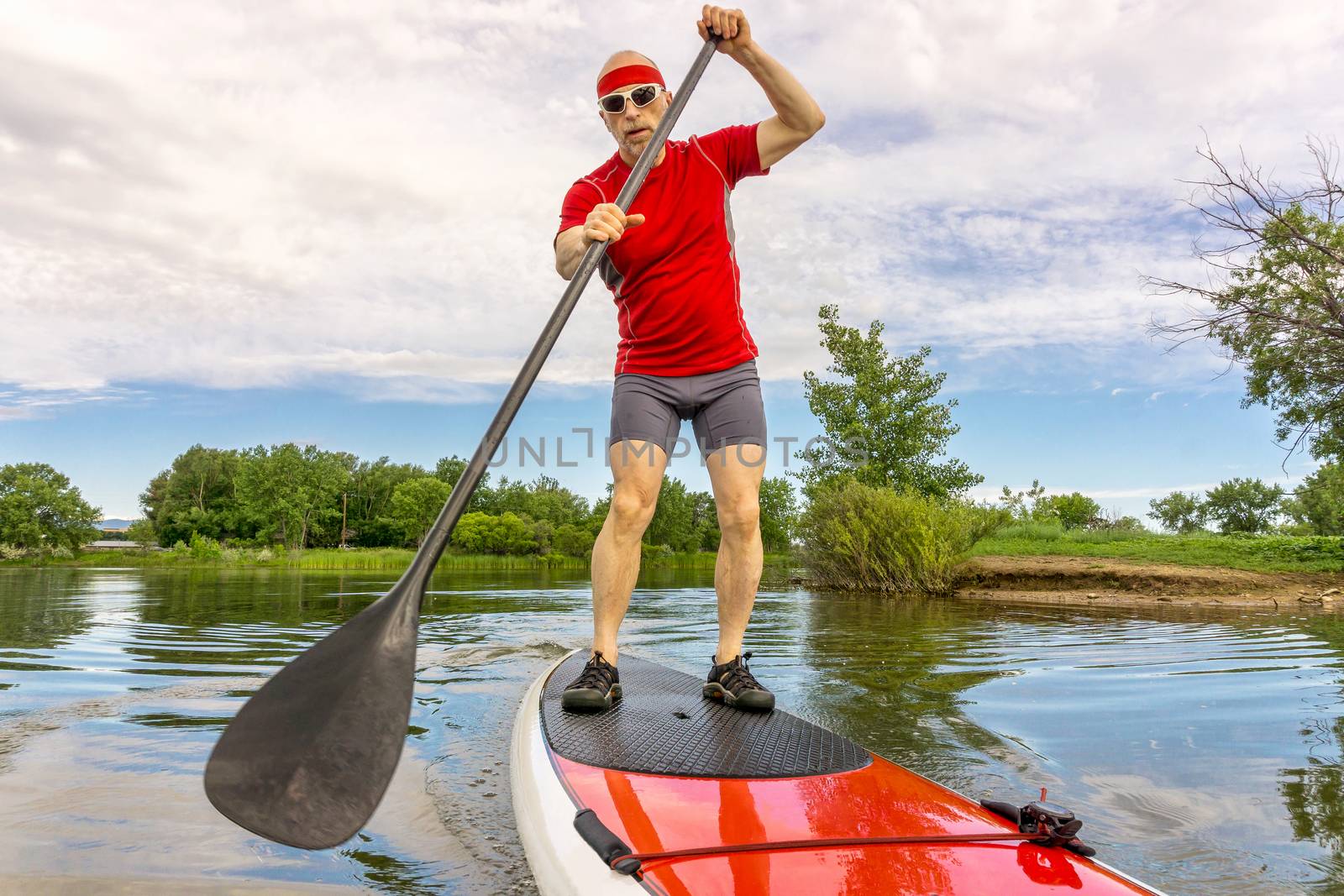 stand up paddling on a lake in Colorado by PixelsAway