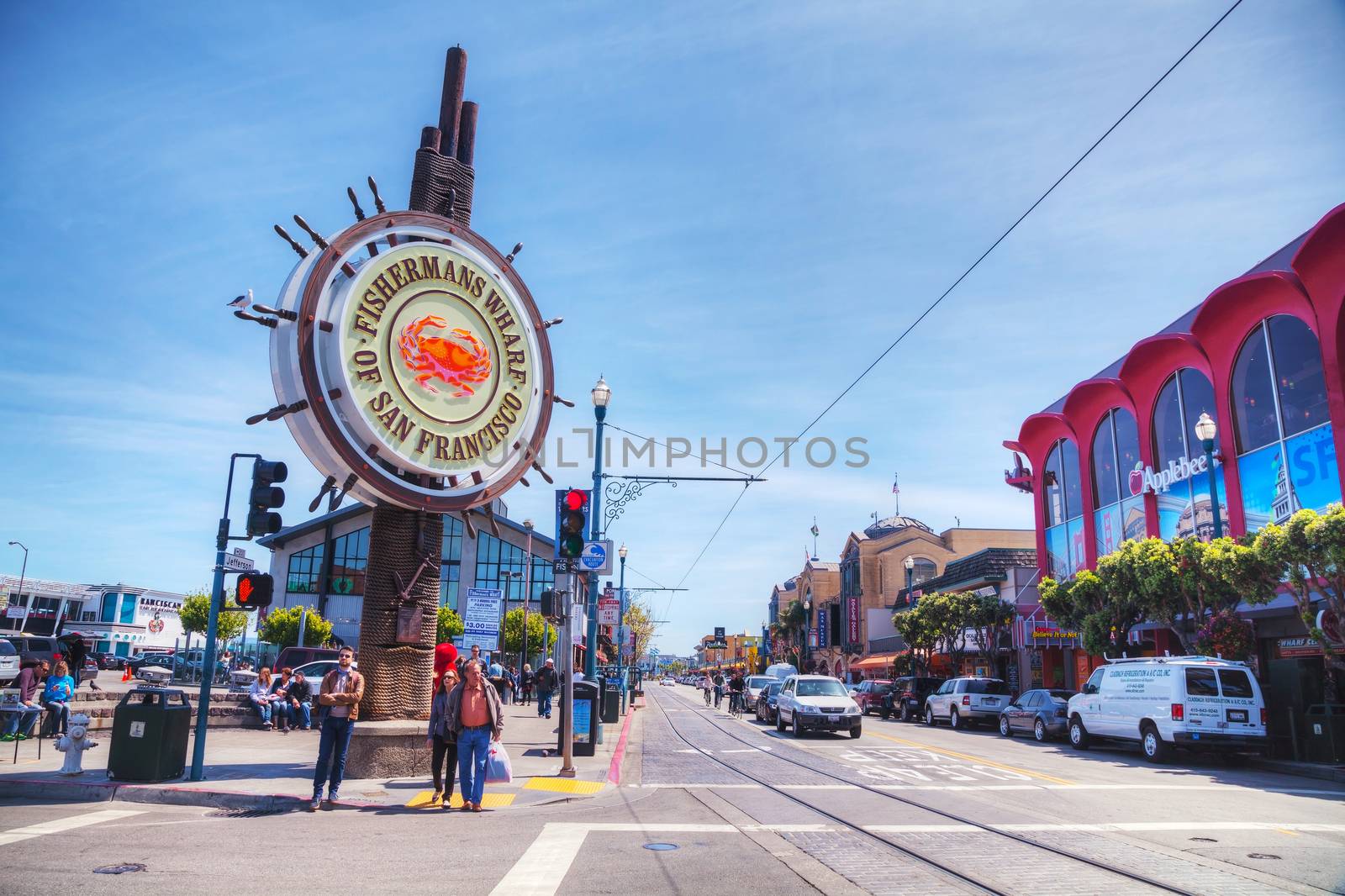 SAN FRANCISCO - APRIL 23: Famous Fisherman's Wharf sign with tourists on April 23, 2014 in San Francisco, California. It's one of the busiest and well known tourist attractions in the western United States.