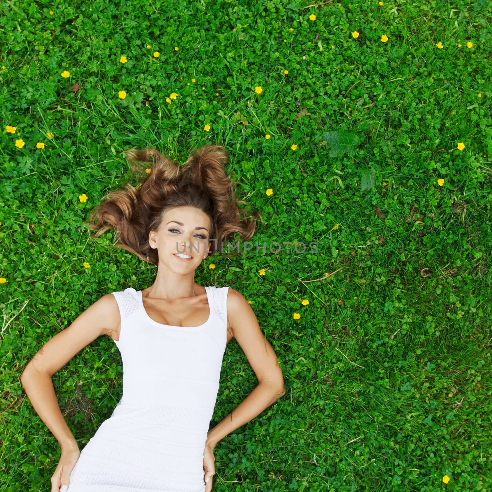 young woman in white dress lying on grass by Yellowj