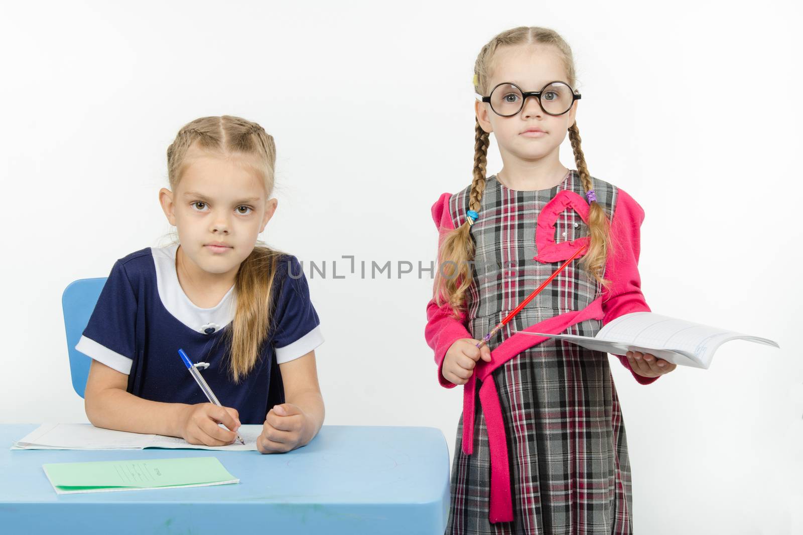 Two girls play school teacher and student