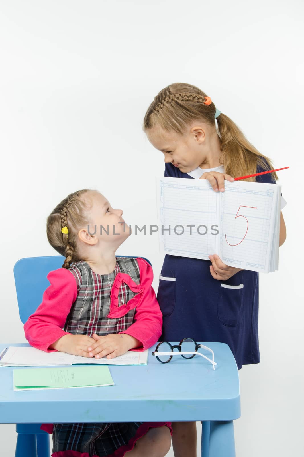 Two girls play school teacher and student