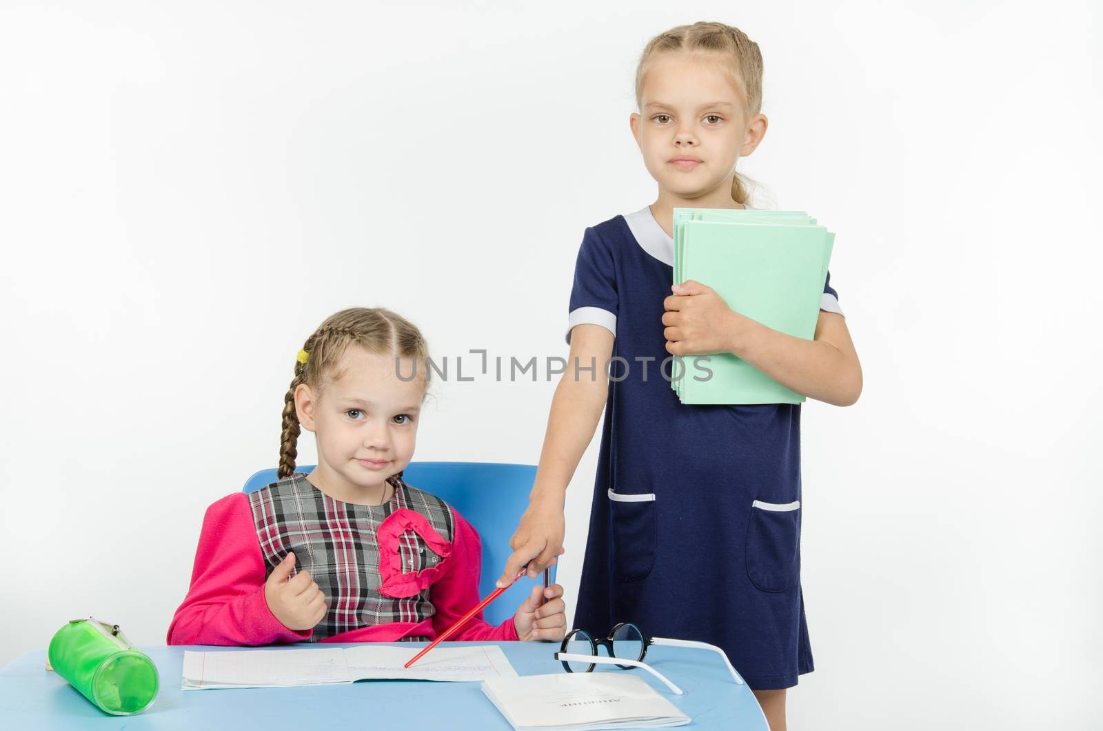 Two girls play school teacher and student