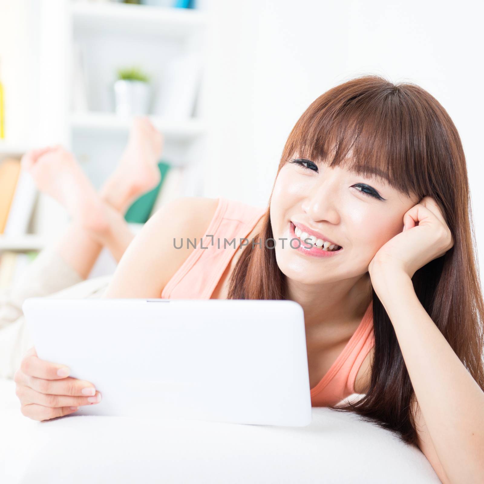 Asian girl relaxed and using tablet by szefei