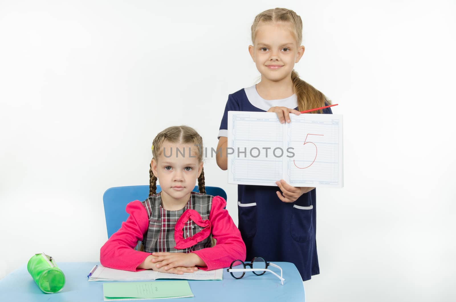 Two girls play school teacher and student