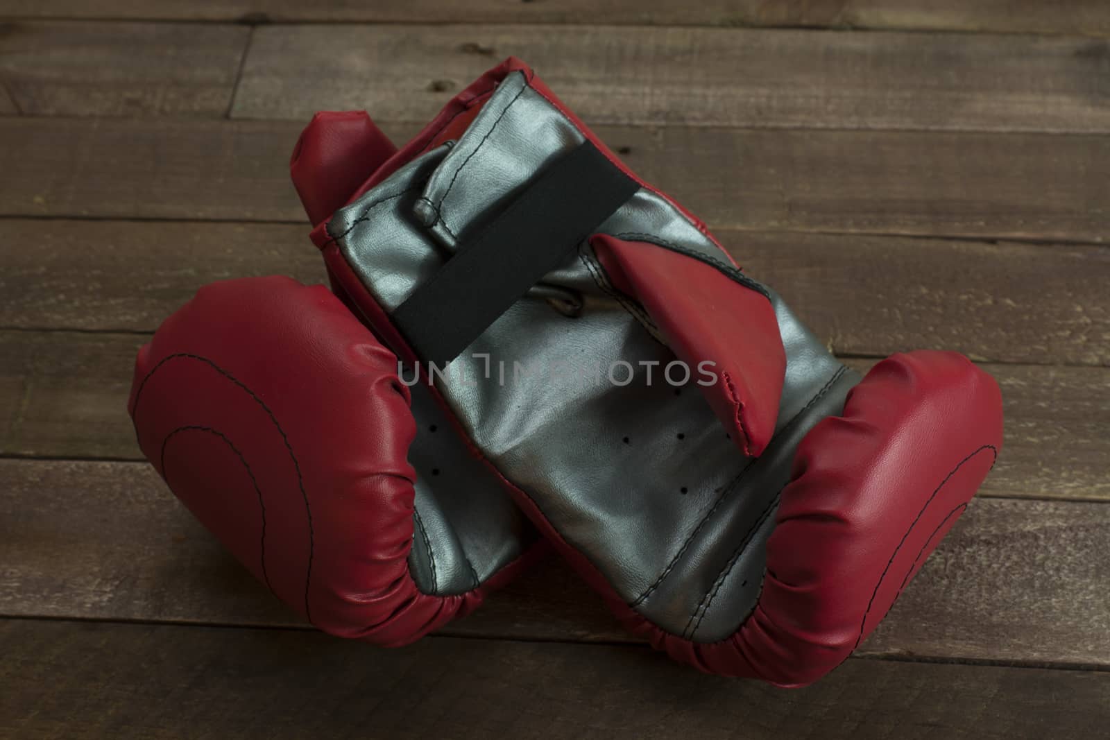 pair of boxing gloves on a wooden floor