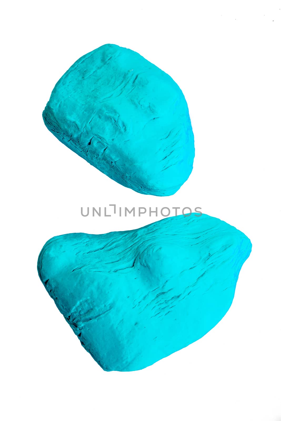 Two used up pieces of blue soap on isolated white background.