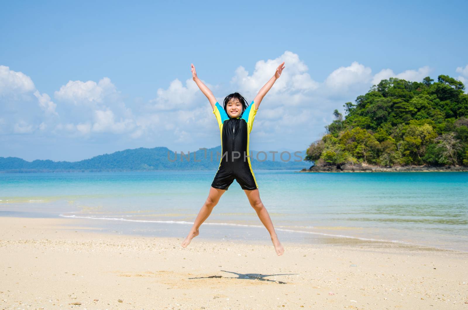 Girl jumping on the beach.
 by chatchai