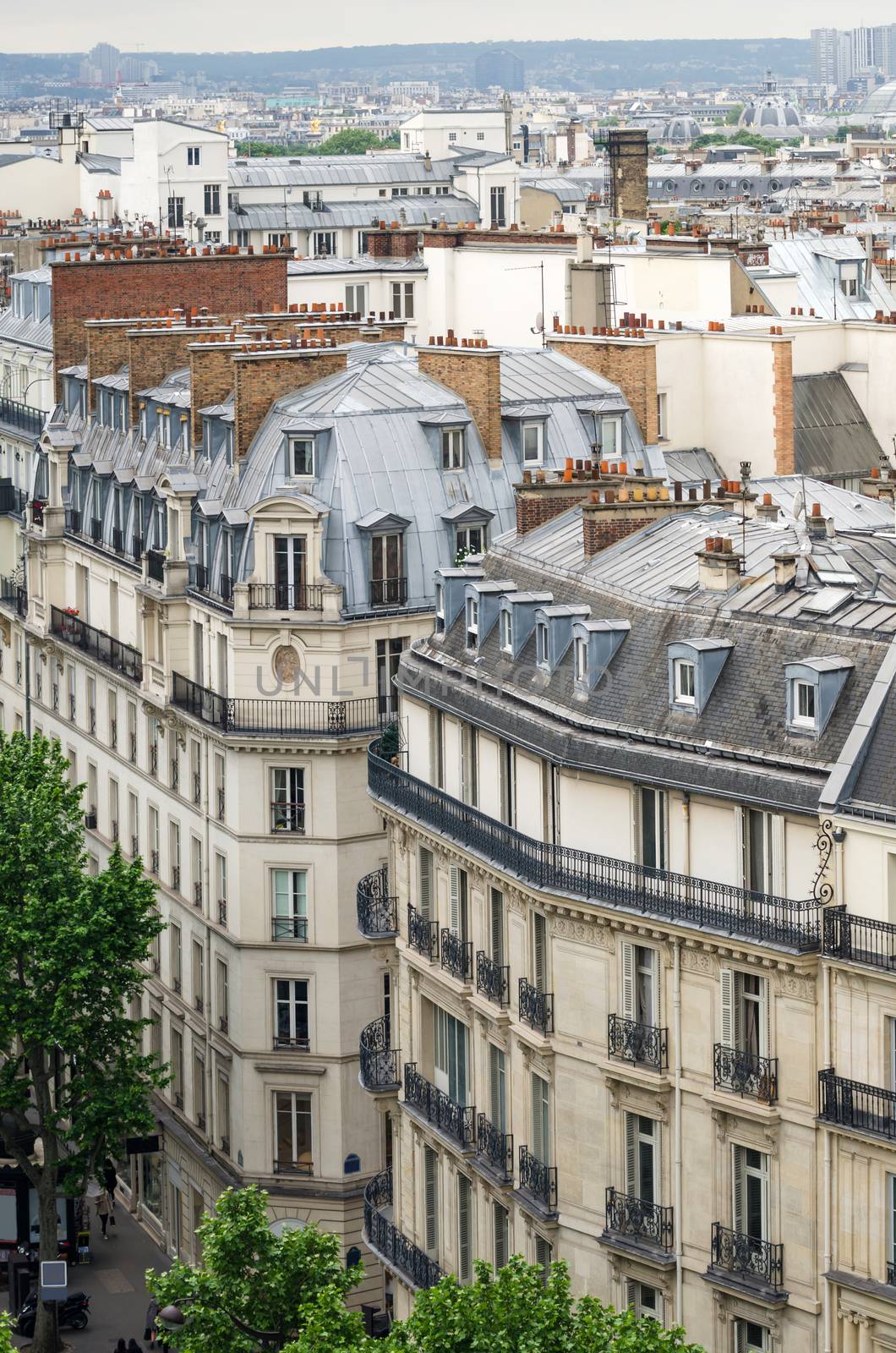 Traditional buildings and street in Paris by siraanamwong