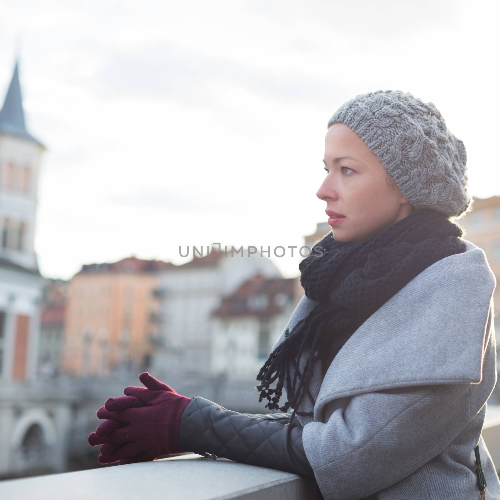 Thoughtful woman outdoors on cold winter day. by kasto