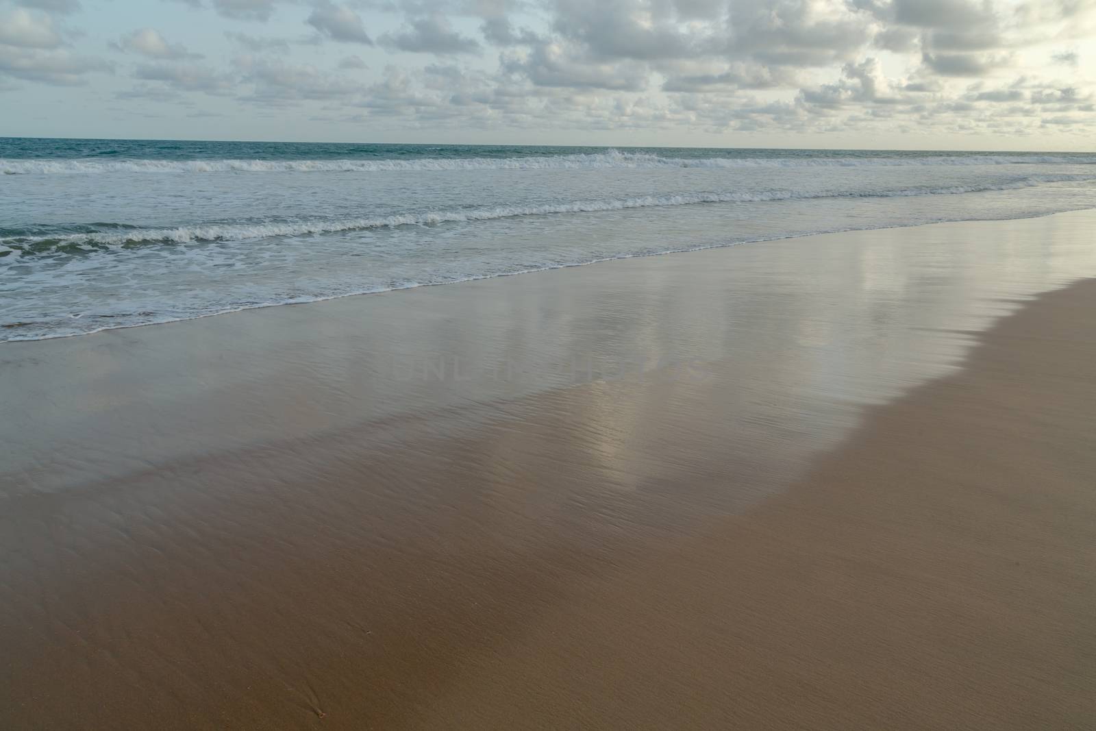 Waves of the Atlantic Ocean landing on the shores of Obama Beach in Cotonou, Benin