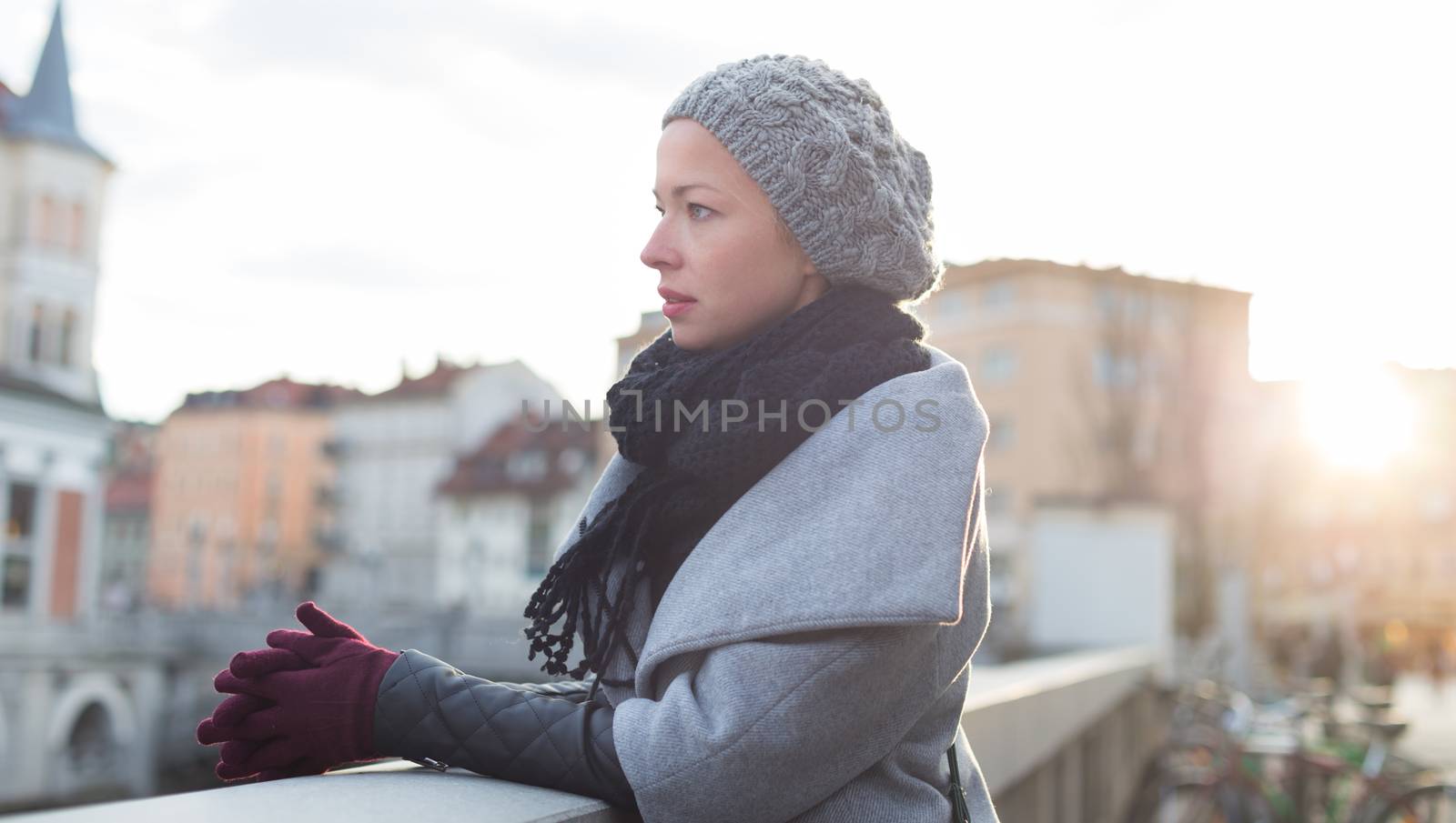 Thoughtful woman outdoors on cold winter day. by kasto