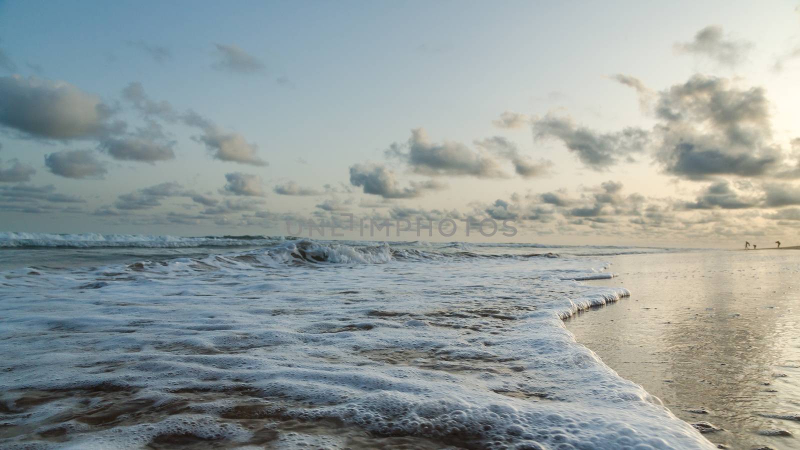 Waves of the Atlantic Ocean landing on the shores of Obama Beach in Cotonou, Benin