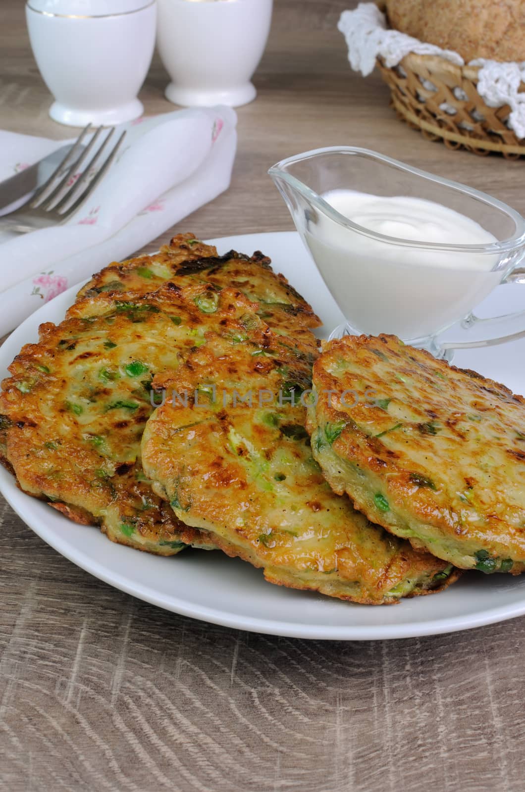 Vegetable fritters of zucchini with peas and herbs