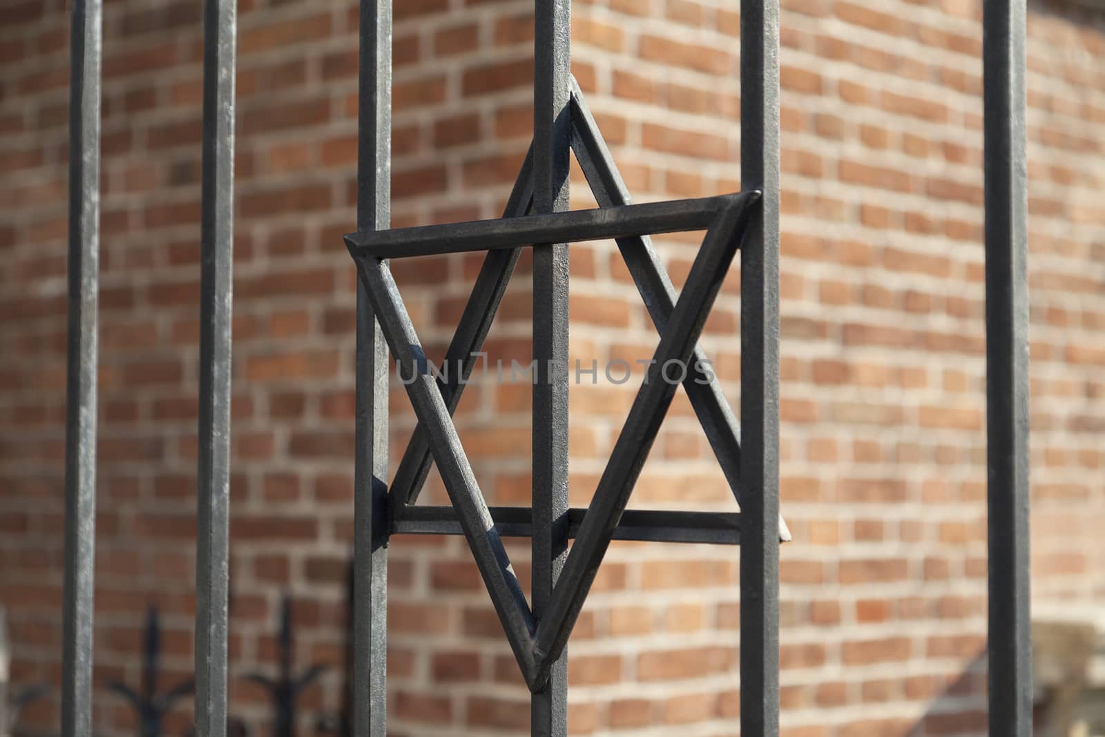 Star of David on metal fence of Old Synagogue in jewish district of Cracow - Kazimierz on Szeroka street in Poland