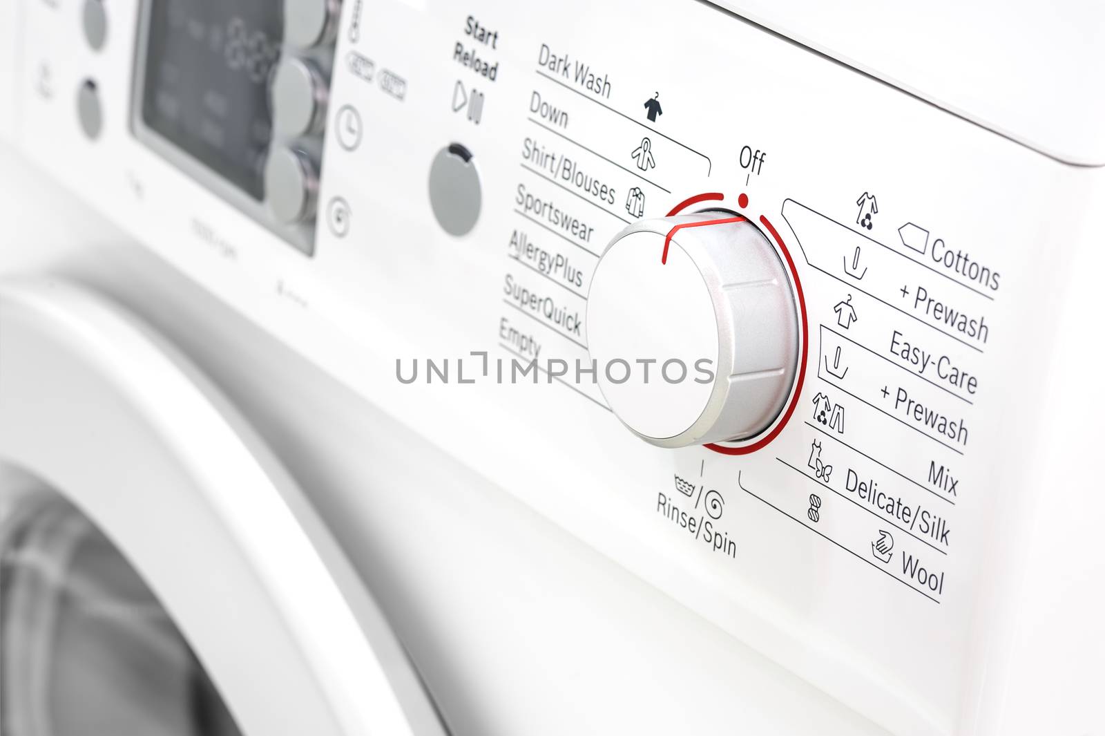 closeup of new white laundry or washing machine, selective focus on control elements