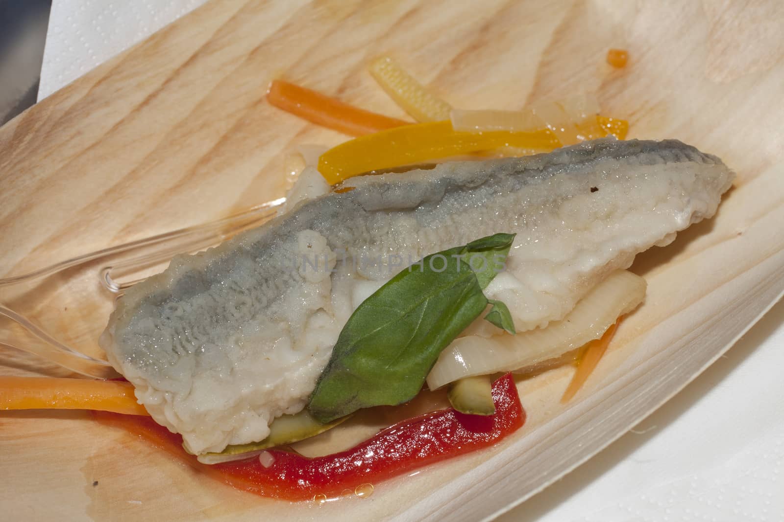 fish fillet on a bed of vegetables, filetto di pesce su letto di verdure