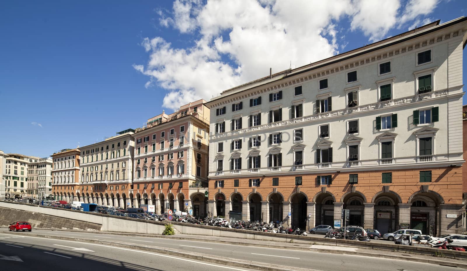 view of Genoa, Italy, historica center with colored houses and red car