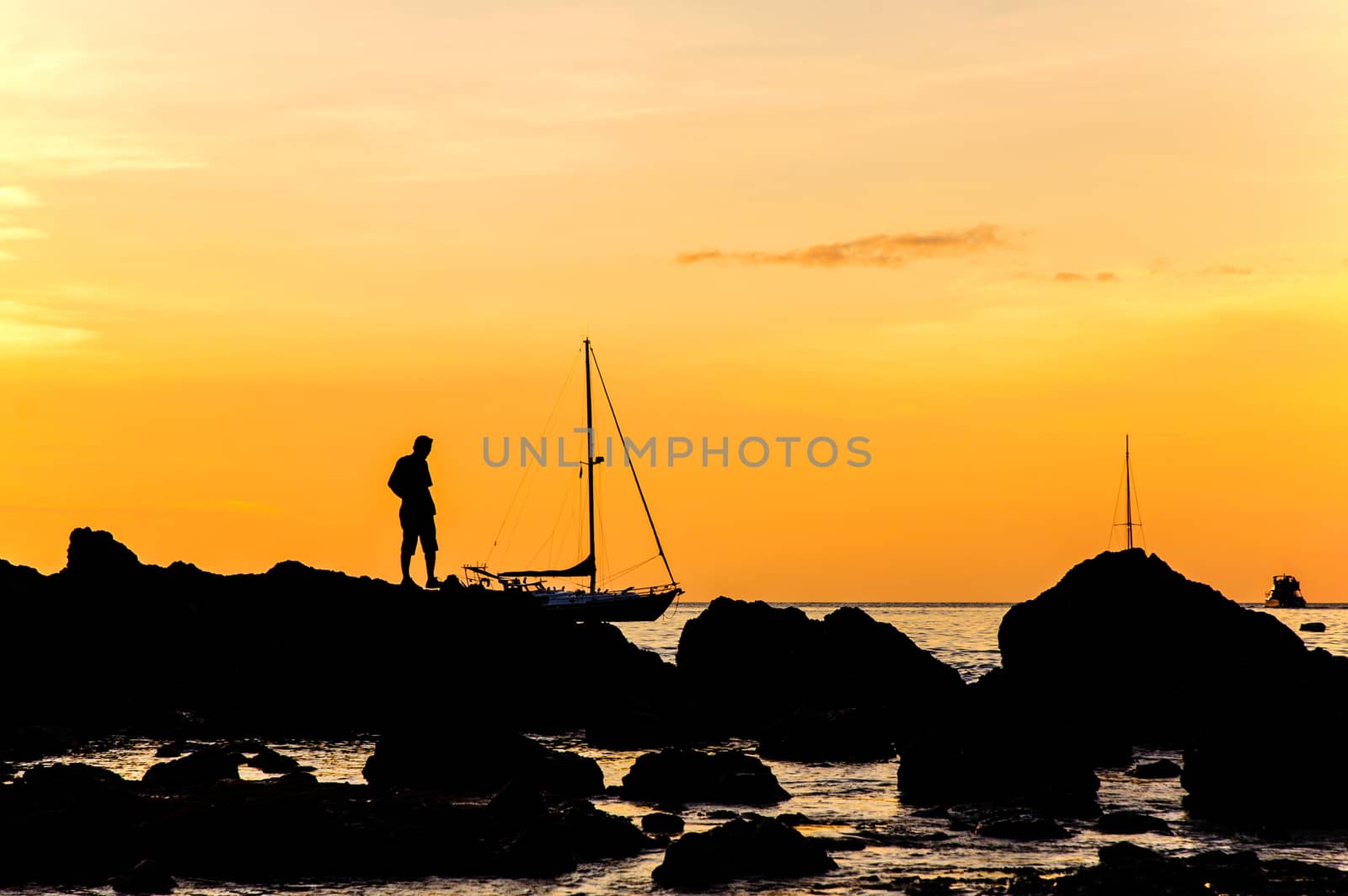 Silhouette with color of the sunset, Phuket Thailand by jimbophoto