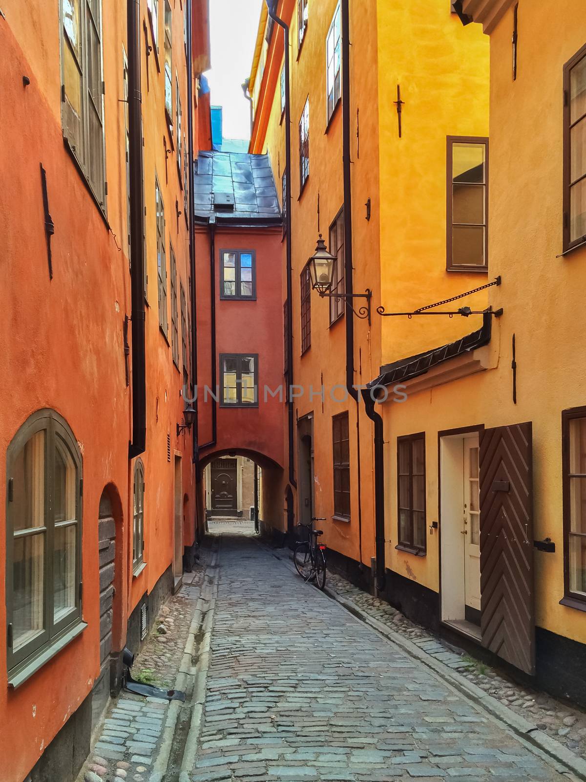 Narrow street with colorful buildings in Gamla Stan, historic center of Stockholm.