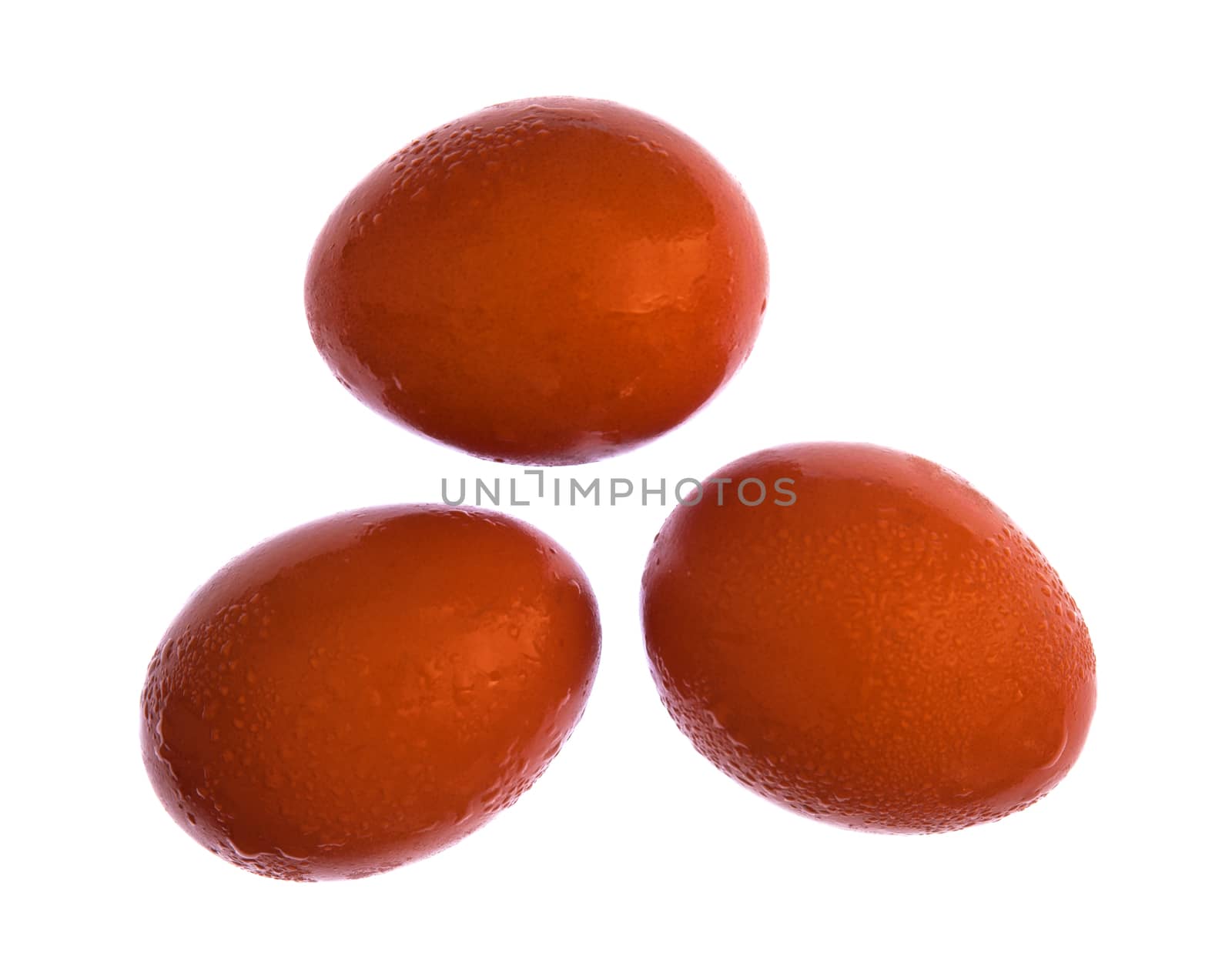 Three eggs isolated on white background through the cleaning clo by jimbophoto