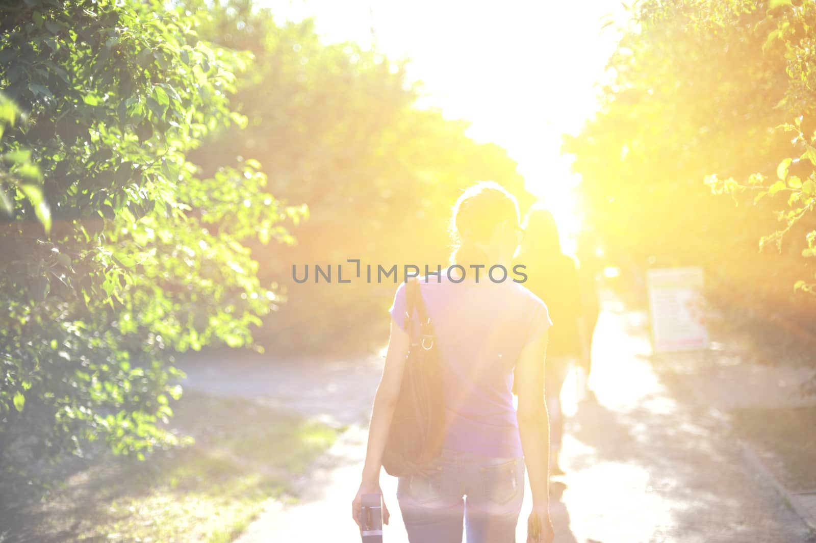 Blurred photo of walking woman on sunrise