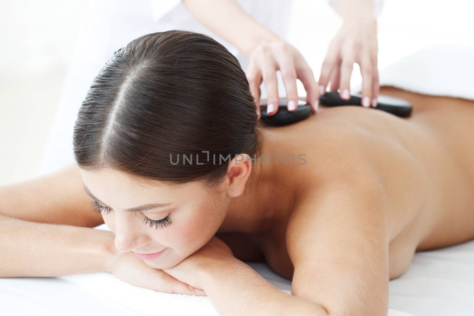 woman having stone therapy at spa session