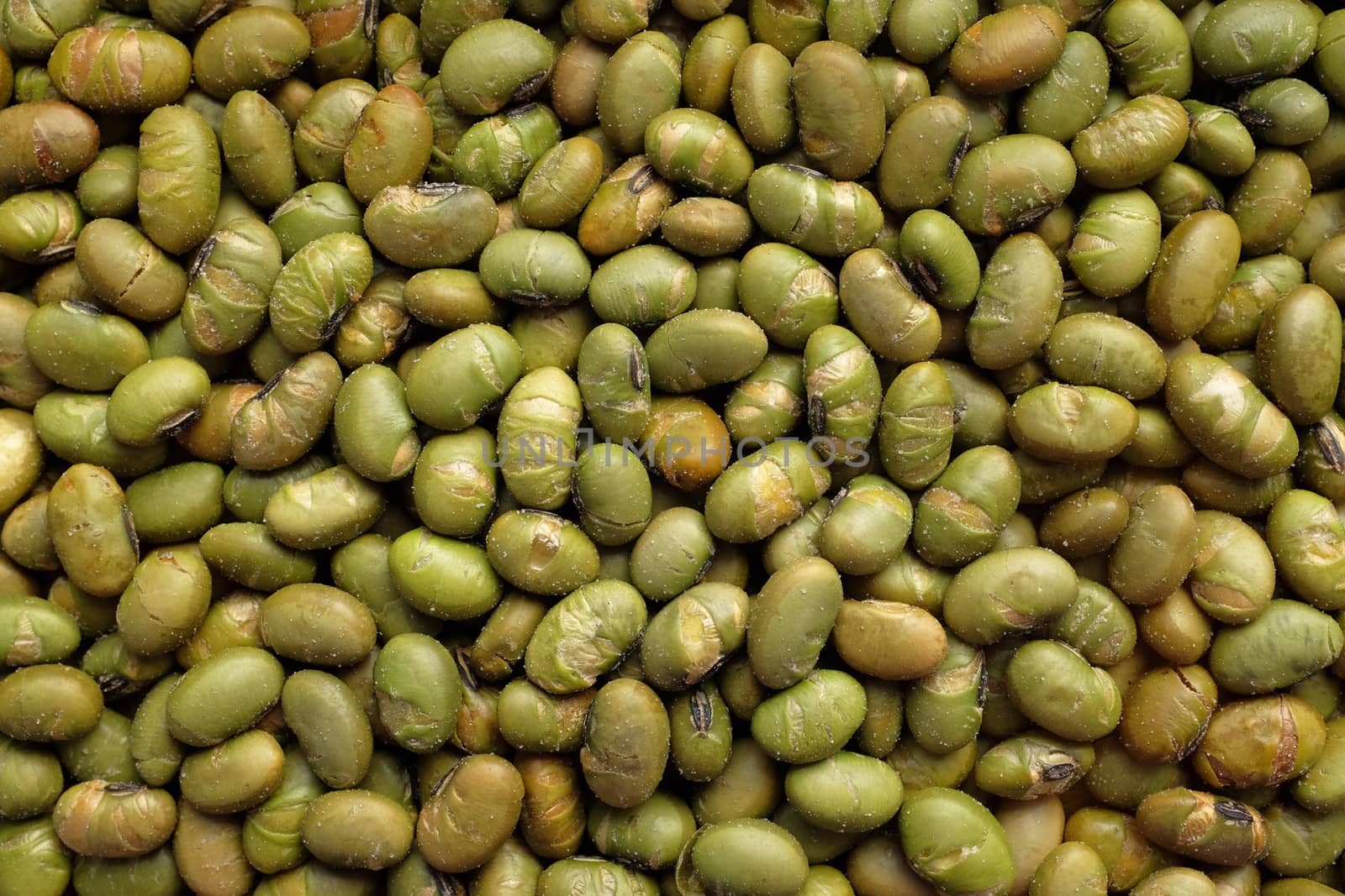 Roasted salted soy nuts as an abstract background texture