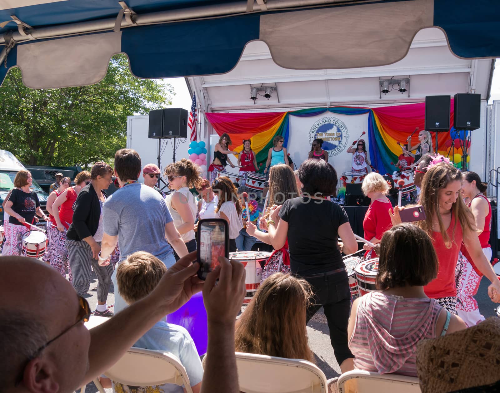 Nyack, NY, USA - June 14, 2015: Members of Batala NYC dancing with viewers before the stage during Rockland County Pride.