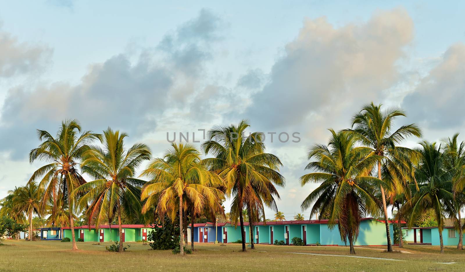 Beautiful sunset over the sea with a view at palms on  beach on a Cuba island 