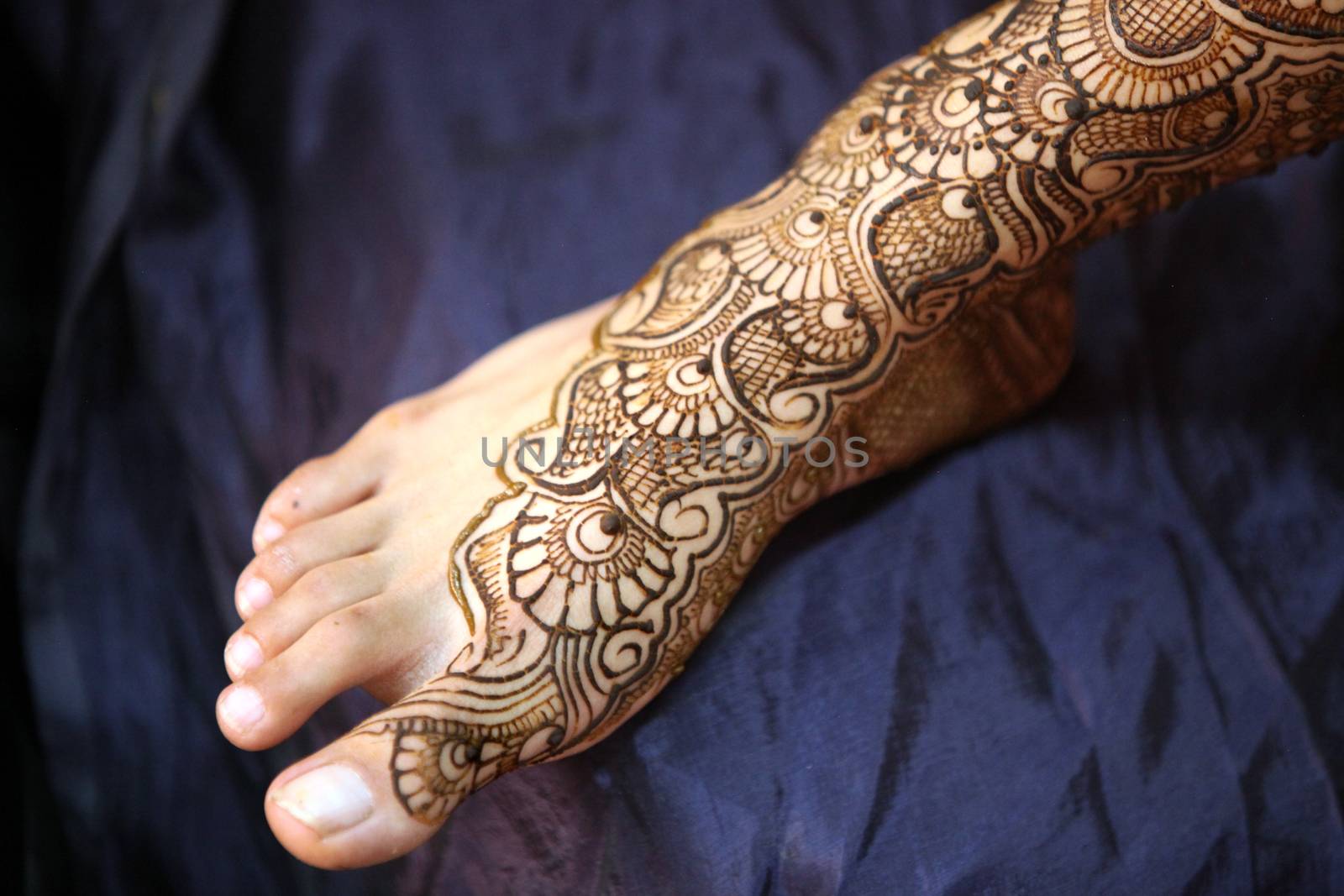 A Indian bride's feet with beautiful traditional design of mehendi.