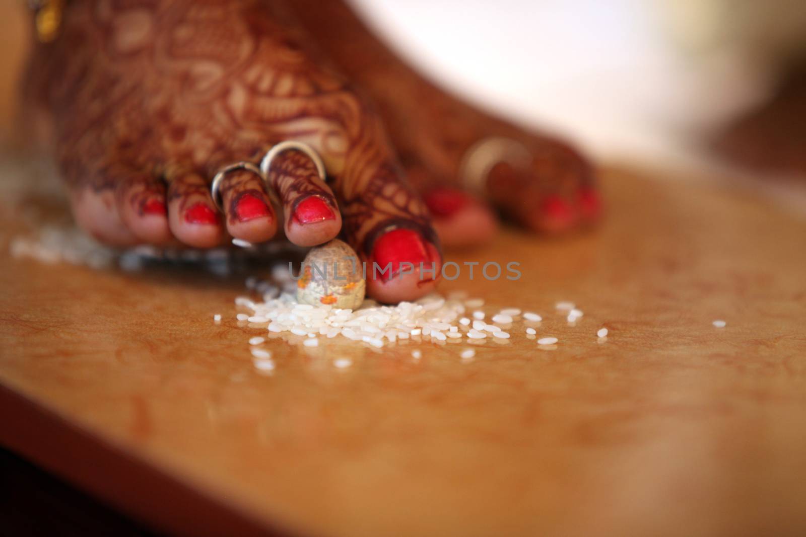 The last steps of the bride among the 7 taken during a traditional hindu religious wedding consisting of a betelnut and rice.