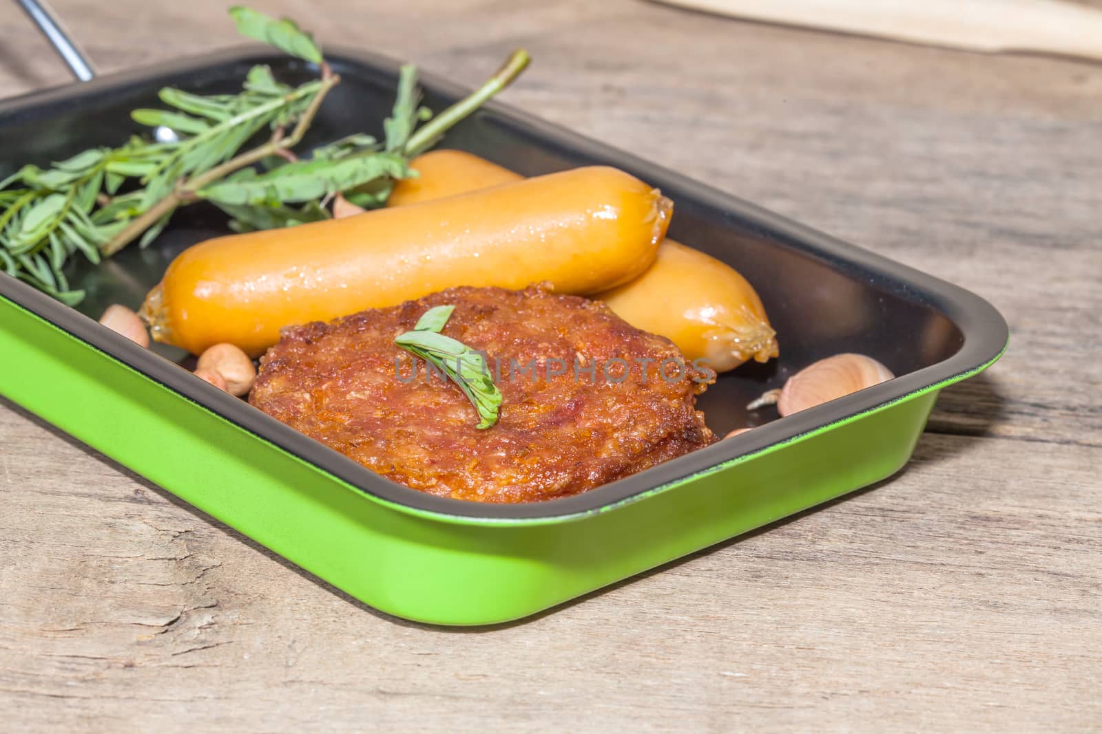 pork fried and  sausages in pan 