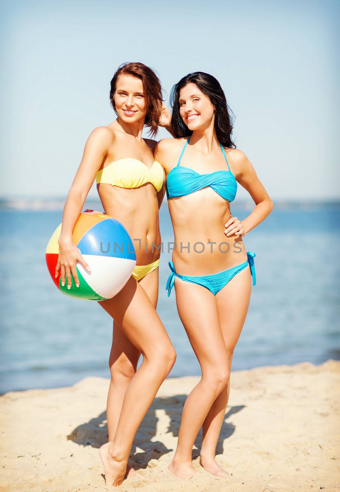 girls with ball on the beach by dolgachov