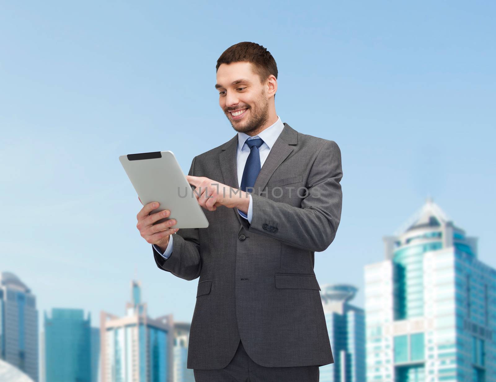 business and technology concept - smiling businessman with tablet pc computer