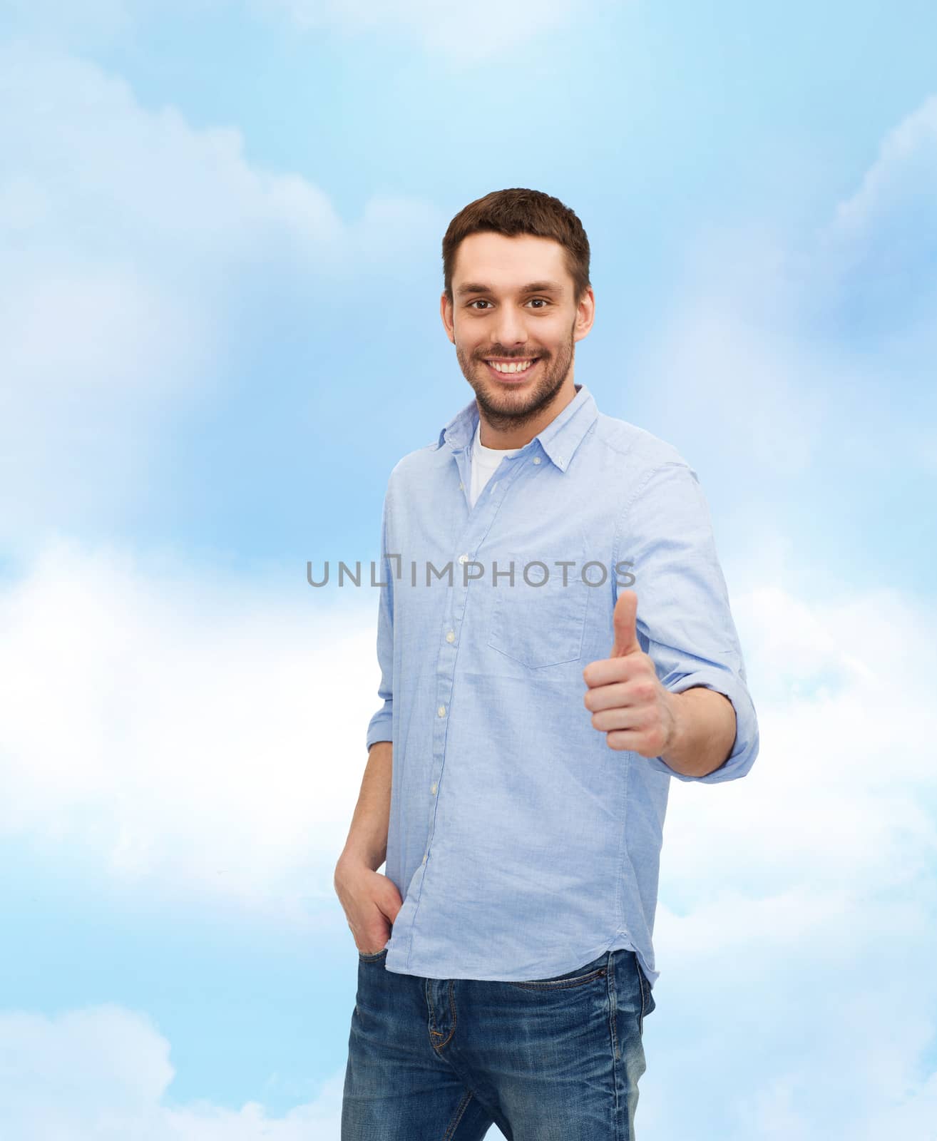 smiling man showing thumbs up by dolgachov