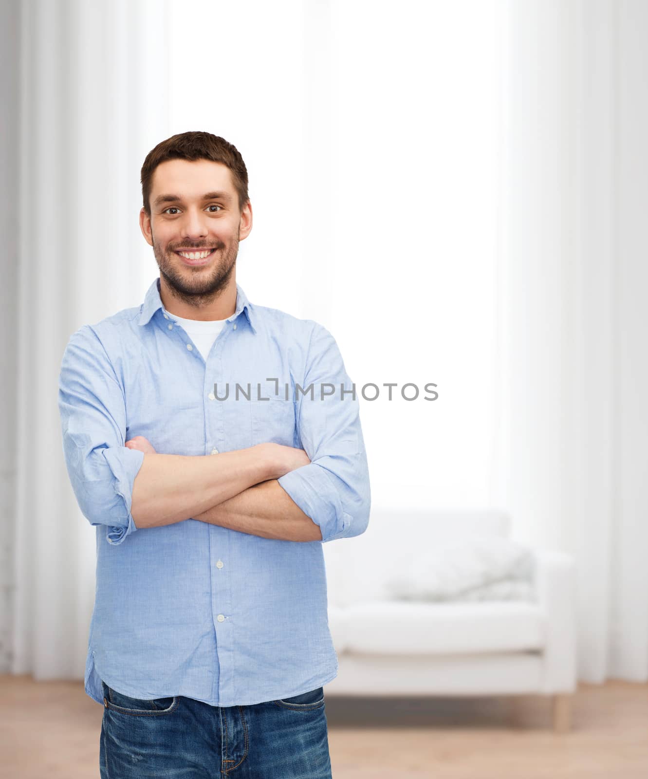 happiness and people concept - smiling man with crossed arms