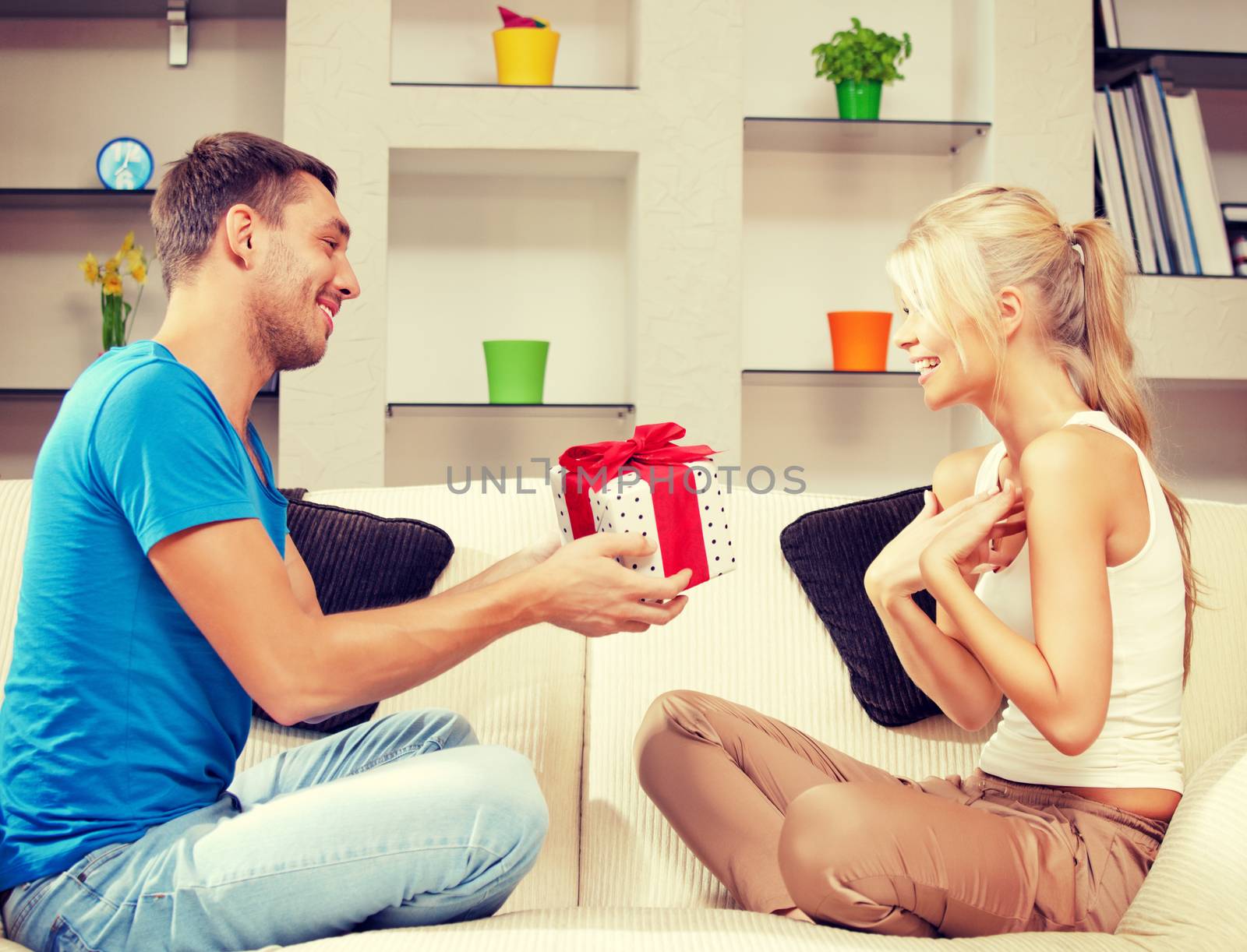 happy romantic couple with gift by dolgachov