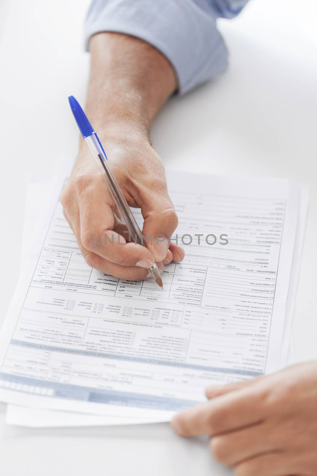 business, tax, office, school and education concept - man filling a form