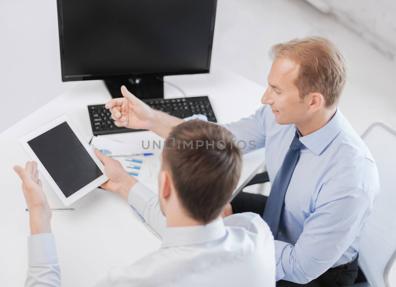 business, technology and office concept - businessmen with notebook and tablet pc