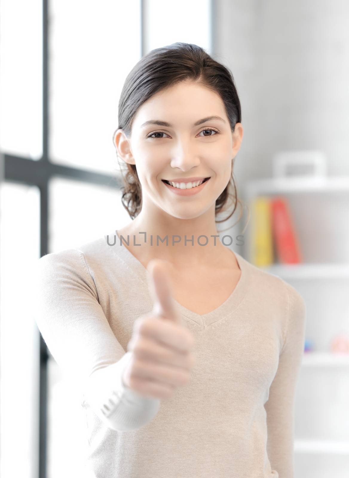 business and education concept - lovely teenage girl showing thumbs up gesture