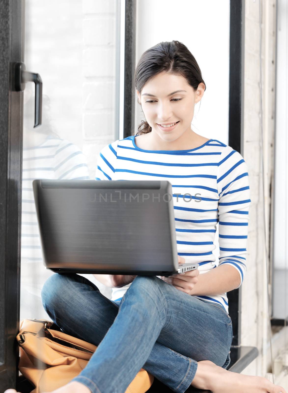happy teenage girl with laptop computer by dolgachov
