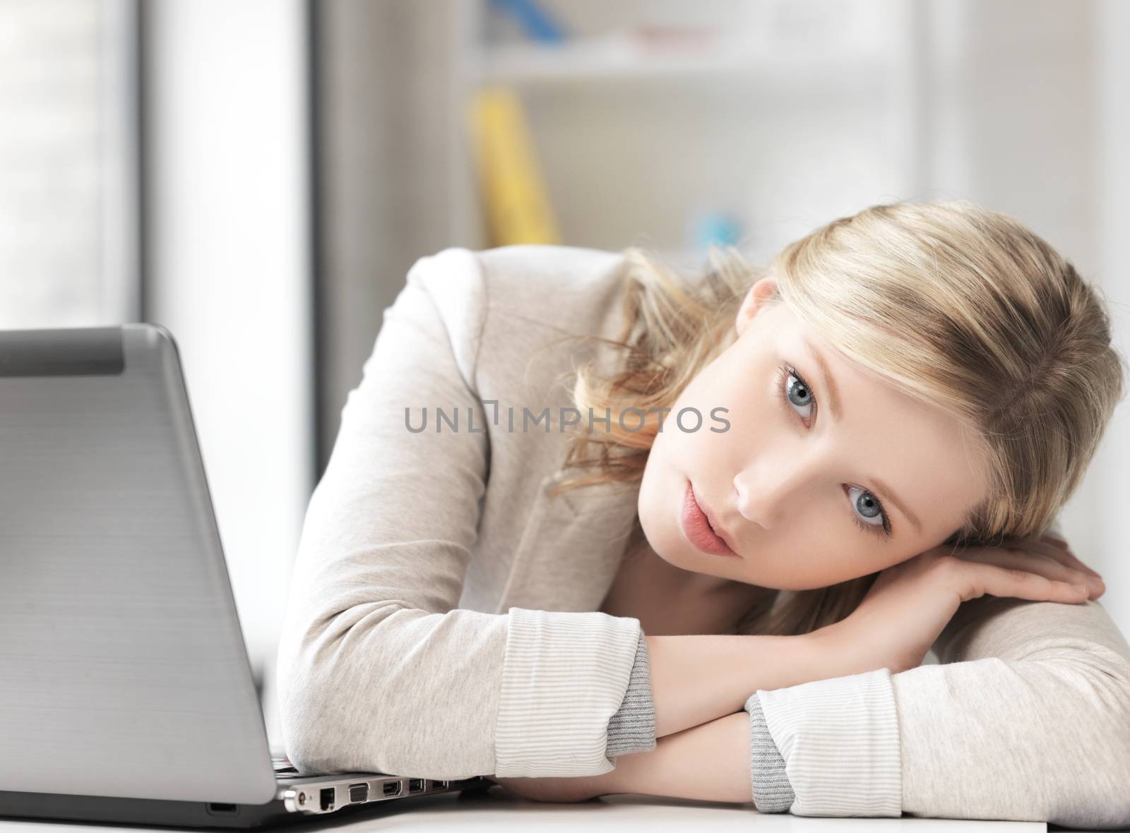 tired woman with laptop computer by dolgachov