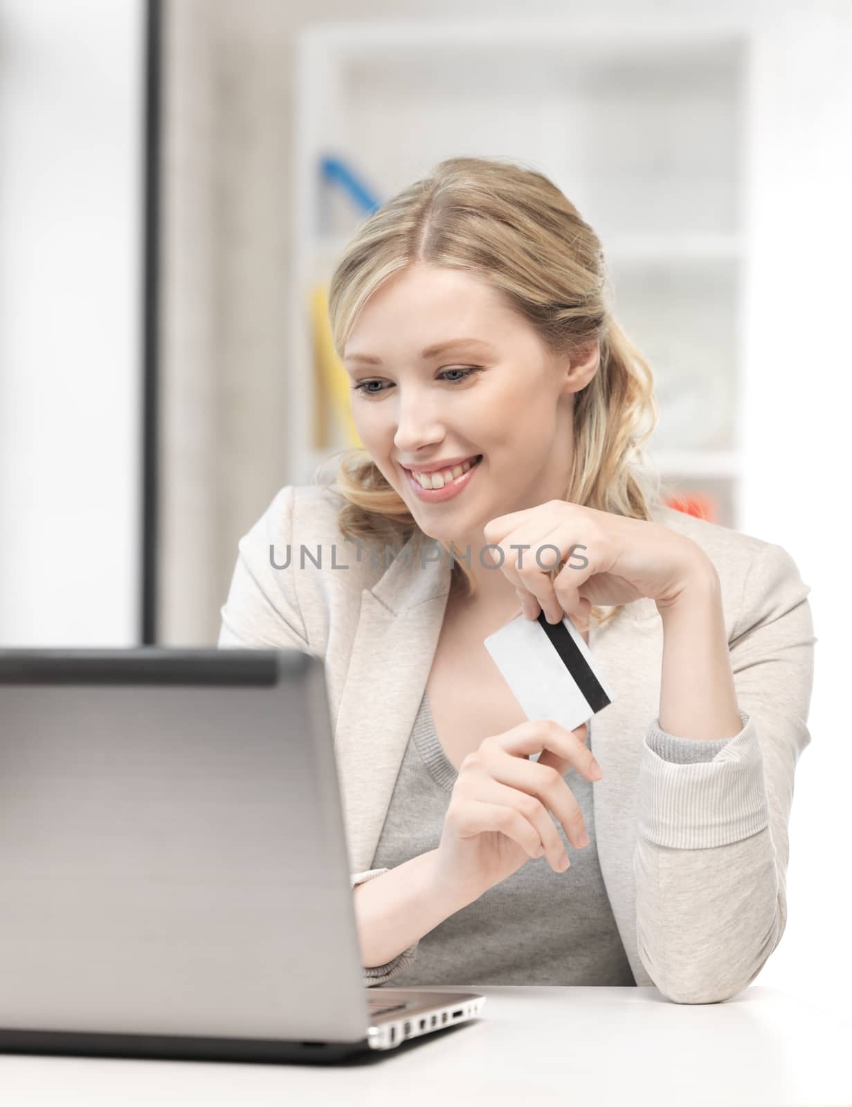 business and technology concept - picture of happy woman with laptop computer and credit card
