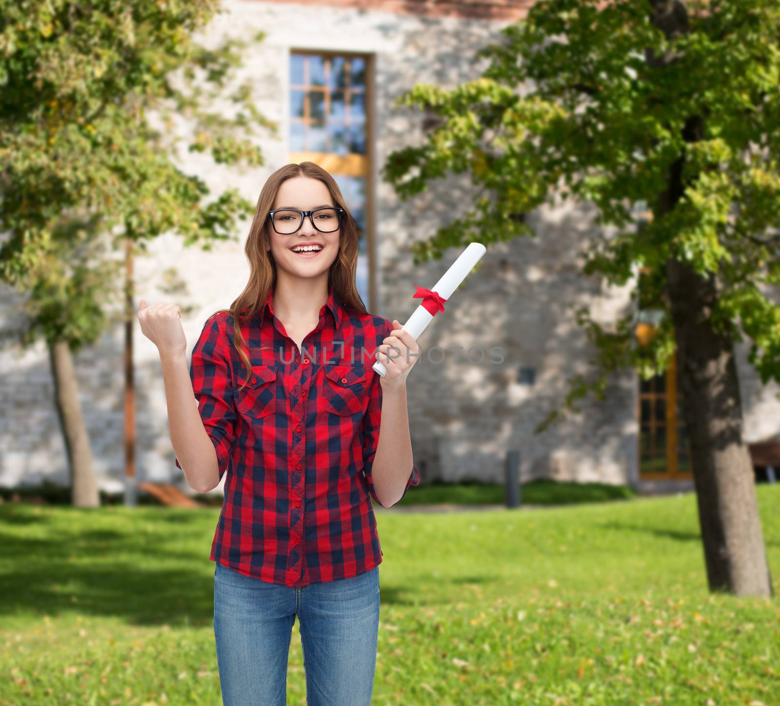 university and education concept - smiling female student in eyeglasses with diploma