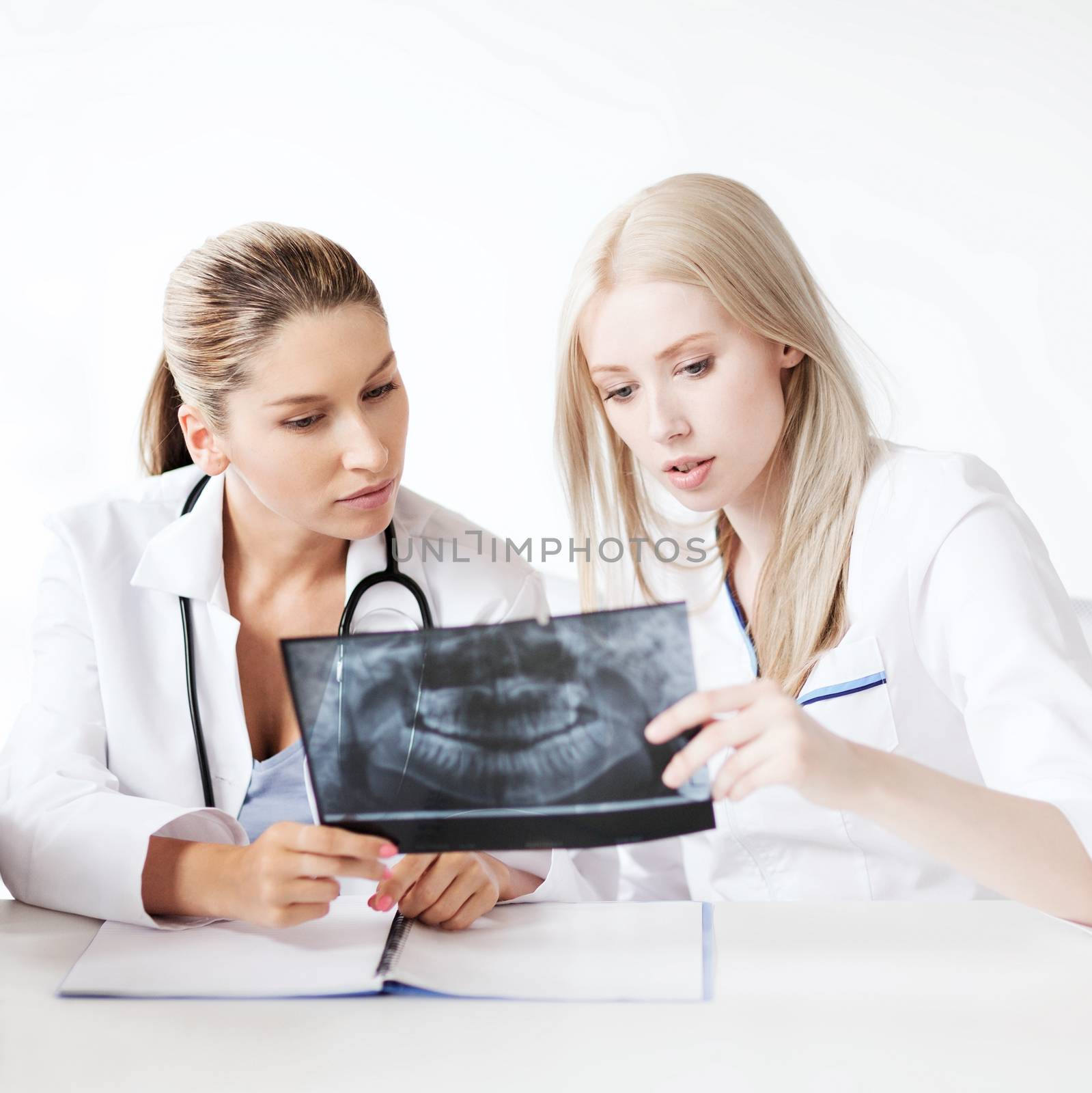 healthcare, medical and radiology concept - group of doctors looking at x-ray