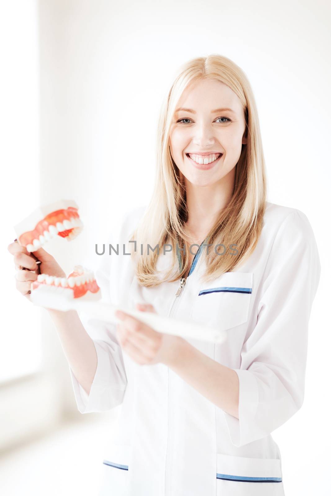 healthcare, medical and stomatology - doctor with toothbrush and jaws in hospital