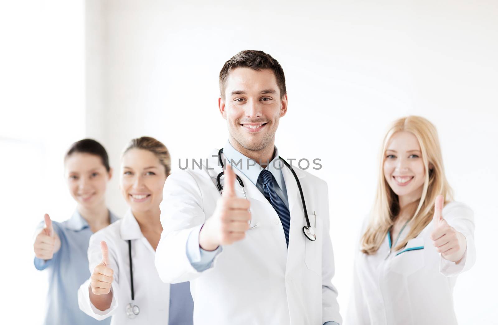 healthcare and medical - professional young team or group of doctors showing thumbs up