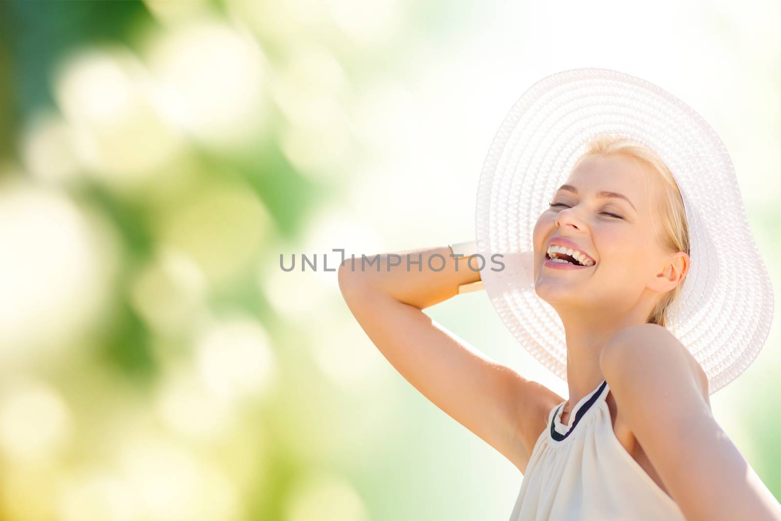 fashion, happiness and lifestyle concept - beautiful woman in hat enjoying summer outdoors