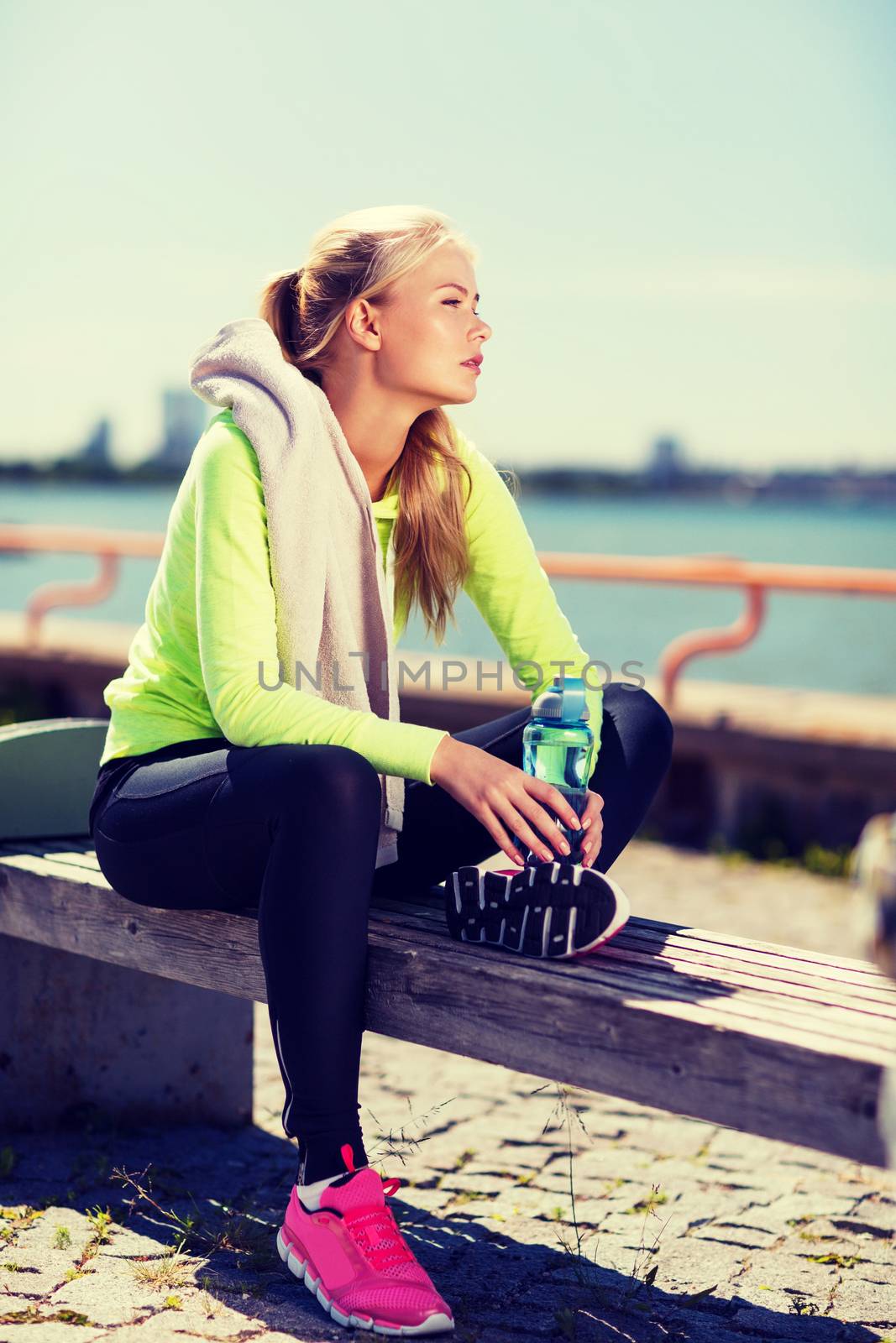 woman resting after doing sports outdoors by dolgachov