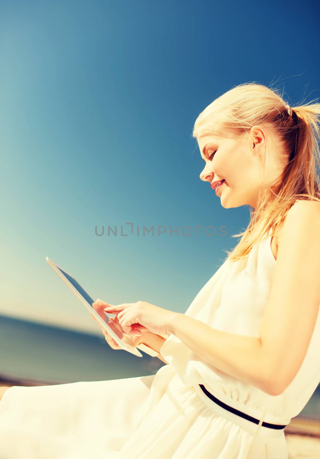 beautiful woman in a dress with tablet pc by dolgachov
